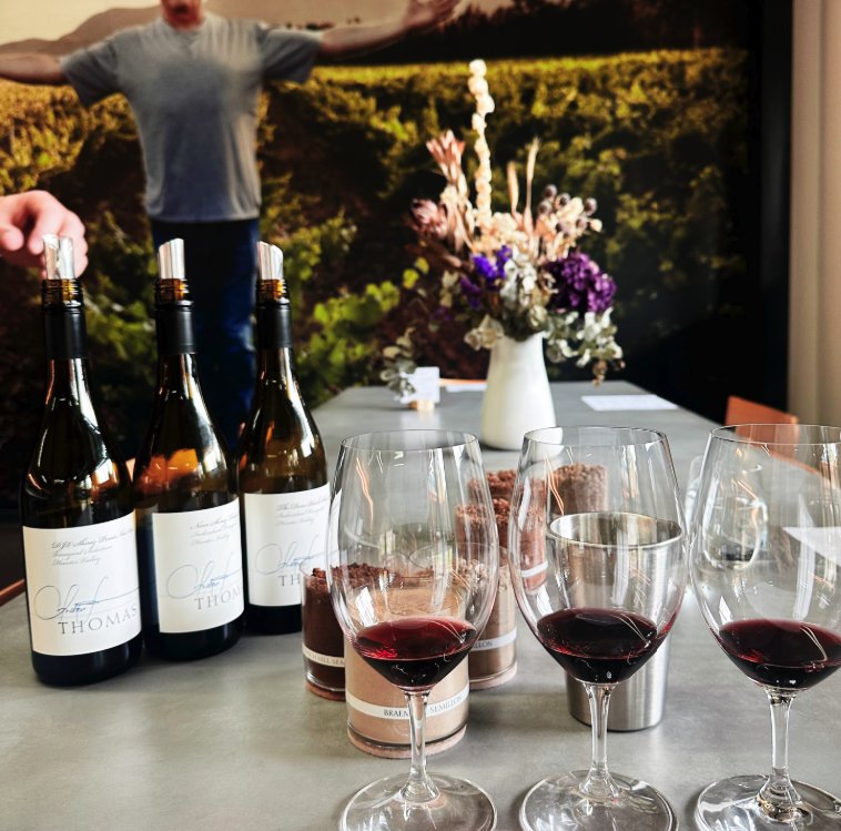 Three Thomas Wines bottles and three poured glasses of Hunter Valley red at a cellar door tasting